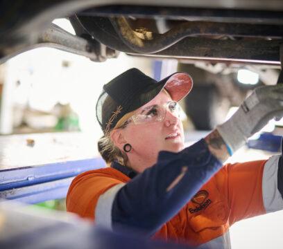 Young woman fixing truck