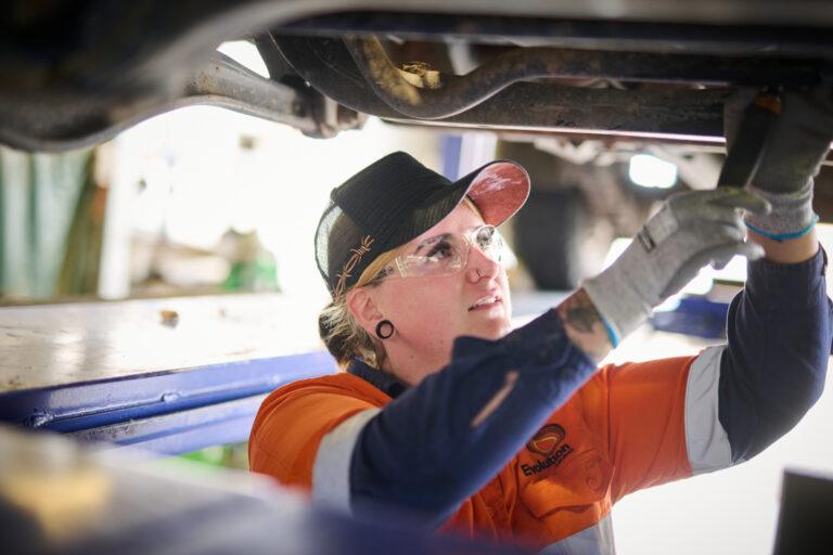 Young woman fixing truck